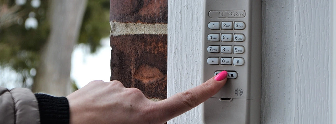 Woman with pink nail polish entering a code to her garage door opener