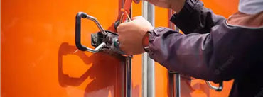 Person sealing their orange garage door